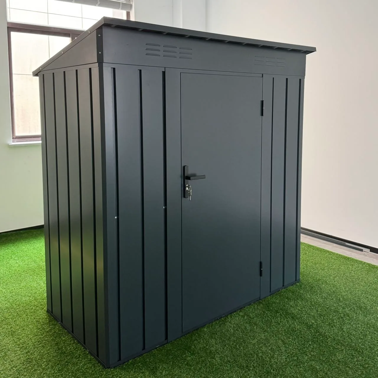 Gray metal garden shed with sliding double doors